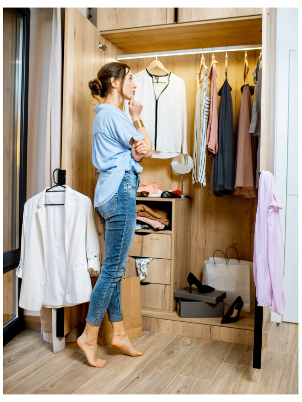 A woman looking at wardrobe for a modest outfit