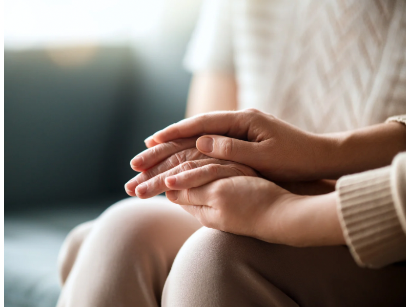a woman holding a child hand as they make short prayers.